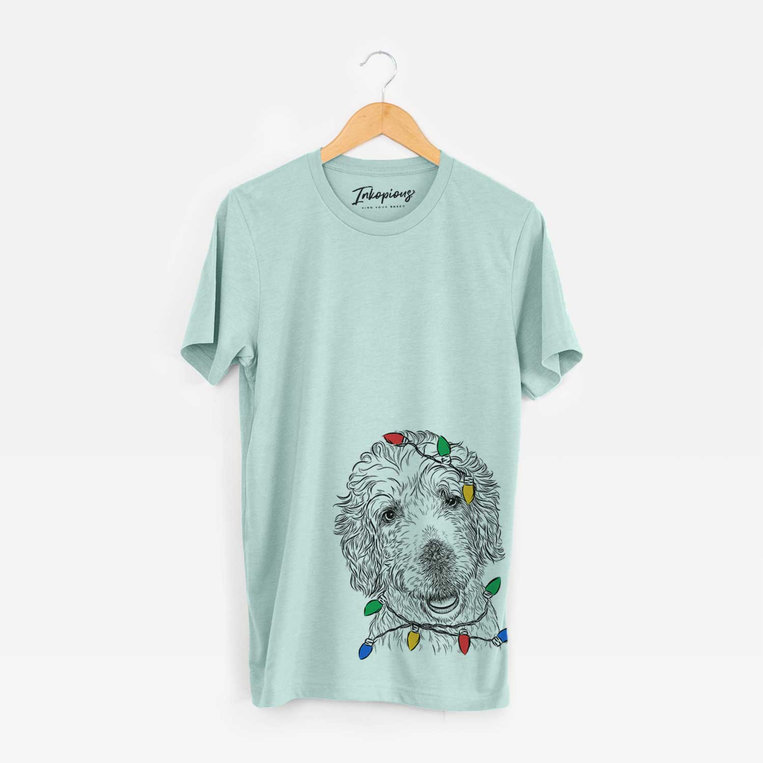Hand-drawn sketch of Preston the Labradoodle wrapped in Christmas lights on a Heather Sage Unisex crewneck