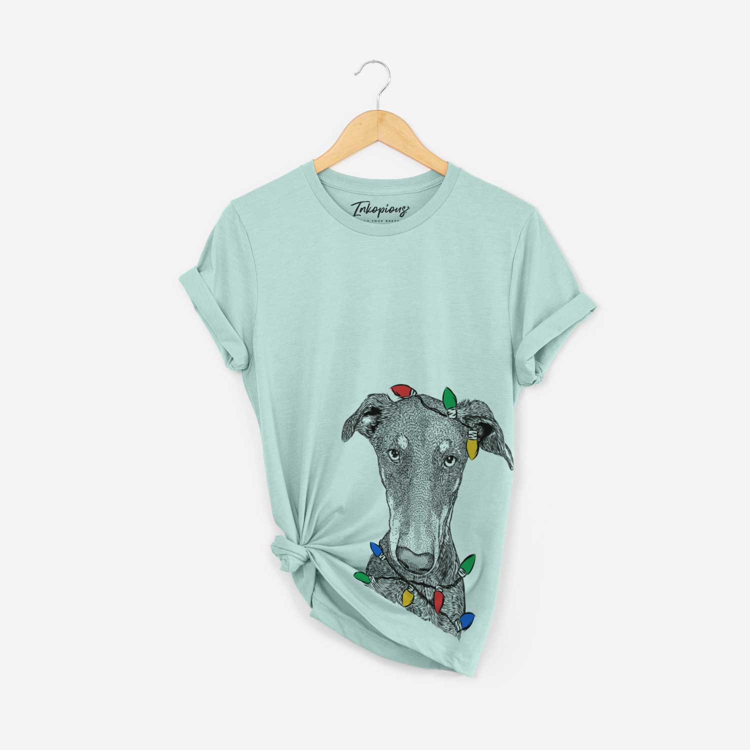 Hand-drawn sketch of Princess Fiona the Doberman Pinscher wrapped in Christmas lights on a Heather Sage Unisex crewneck