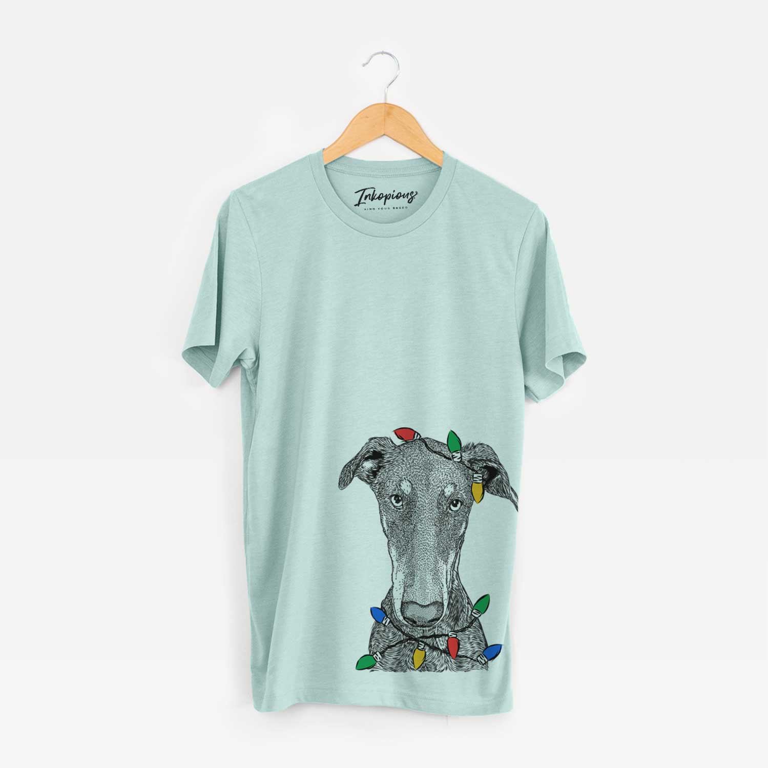 Hand-drawn sketch of Princess Fiona the Doberman Pinscher wrapped in Christmas lights on a Heather Sage Unisex crewneck