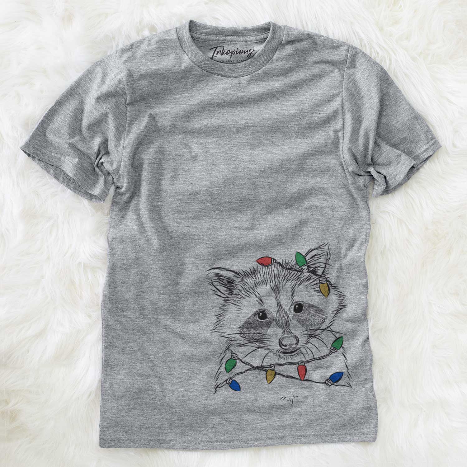 Hand-drawn sketch of Randy the Raccoon wrapped in Christmas lights on a Grey Unisex crewneck
