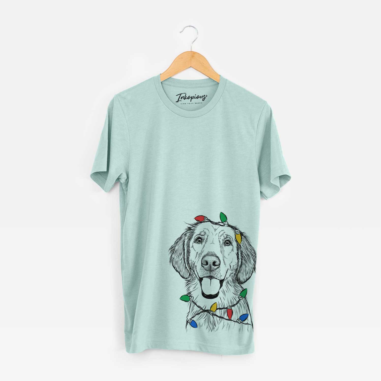 Hand-drawn sketch of Riley the Golden Retriever wrapped in Christmas lights on a Heather Sage Unisex crewneck