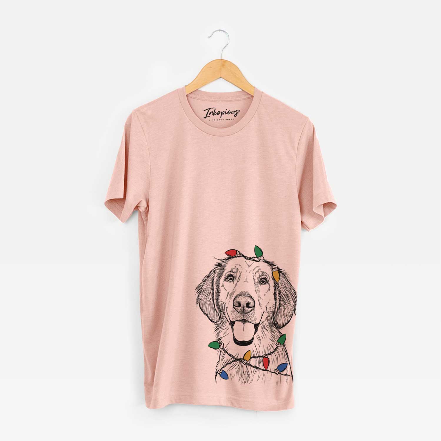 Hand-drawn sketch of Riley the Golden Retriever wrapped in Christmas lights on a Peach Unisex crewneck