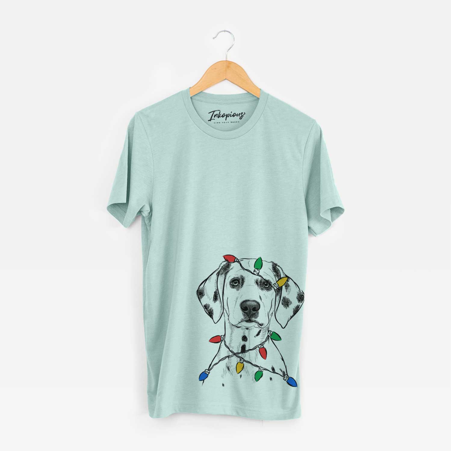 Hand-drawn sketch of Riot the Dalmatian wrapped in Christmas lights on a Heather Sage Unisex crewneck