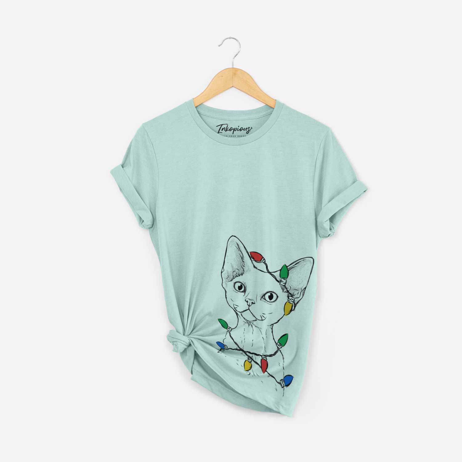 Hand-drawn sketch of Ripley the Devon Rex Cat wrapped in Christmas lights on a Heather Sage Unisex crewneck