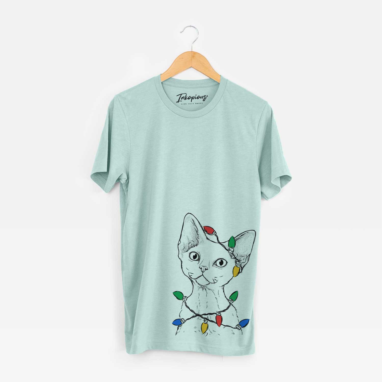Hand-drawn sketch of Ripley the Devon Rex Cat wrapped in Christmas lights on a Heather Sage Unisex crewneck