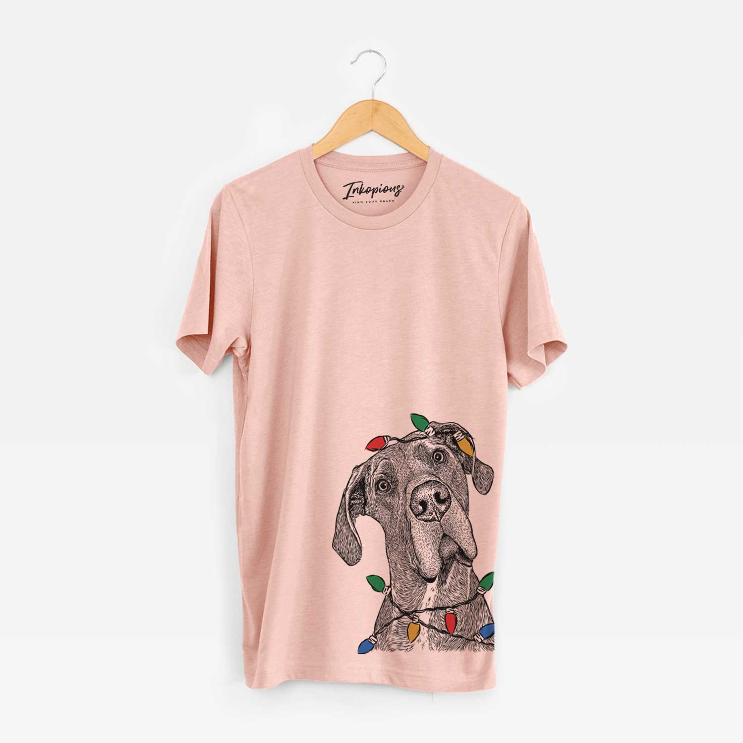 Hand-drawn sketch of River the Great Dane wrapped in Christmas lights on a Peach Unisex crewneck