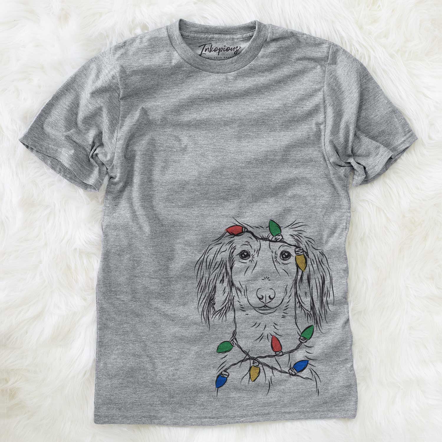 Hand-drawn sketch of Roux the Long Haired Dachshund wrapped in Christmas lights on a Grey Unisex crewneck
