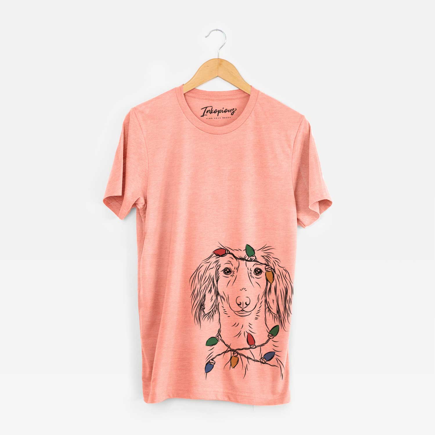 Hand-drawn sketch of Roux the Long Haired Dachshund wrapped in Christmas lights on a Sunset Unisex crewneck
