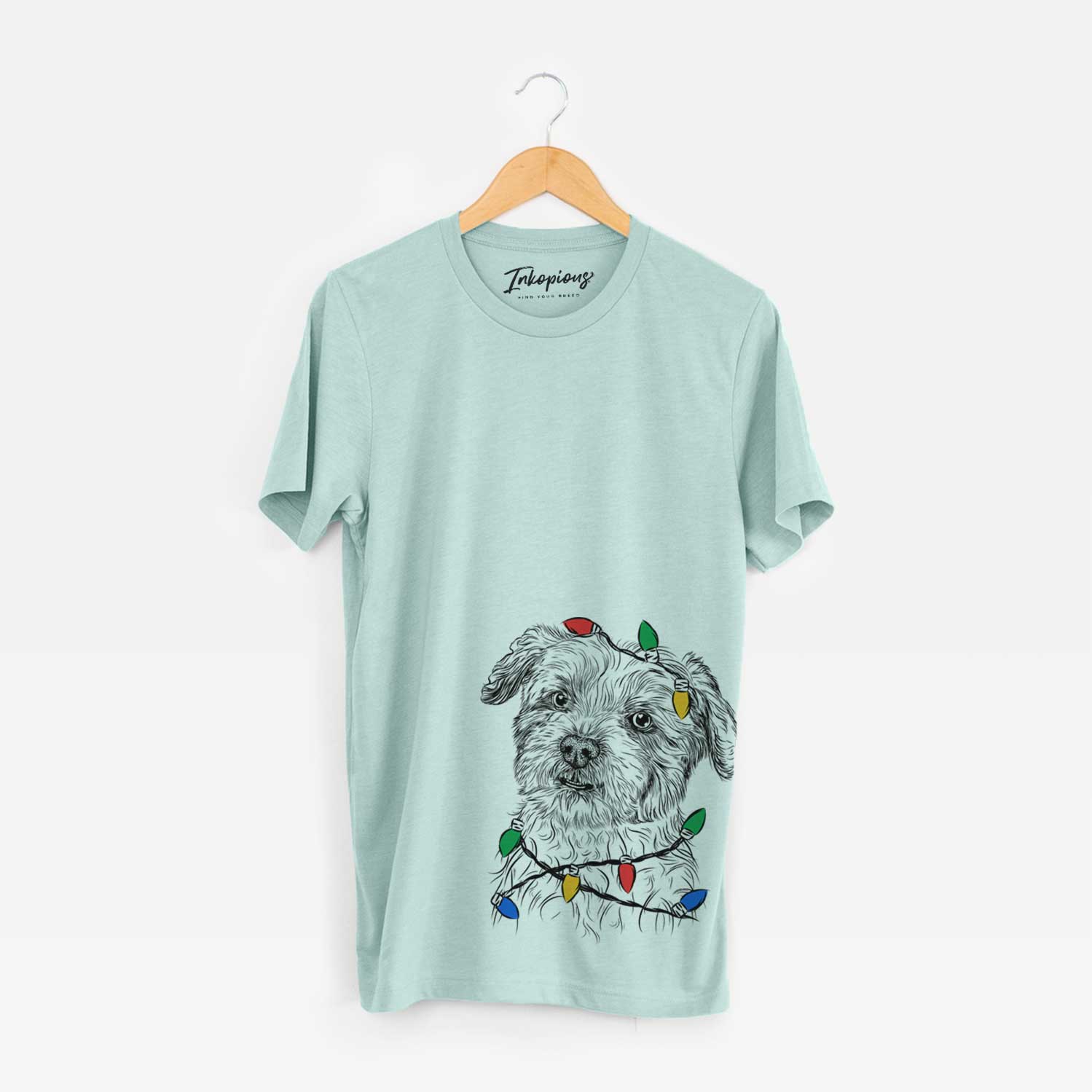 Hand-drawn sketch of Roxie the Schnauzer Shih Tzu Mix wrapped in Christmas lights on a Heather Sage Unisex crewneck