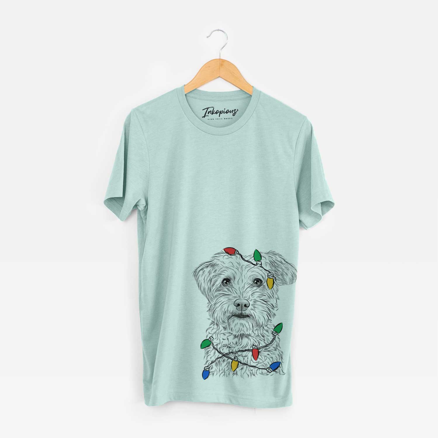 Hand-drawn sketch of Rudy the Schnoodle wrapped in Christmas lights on a Heather Sage Unisex crewneck