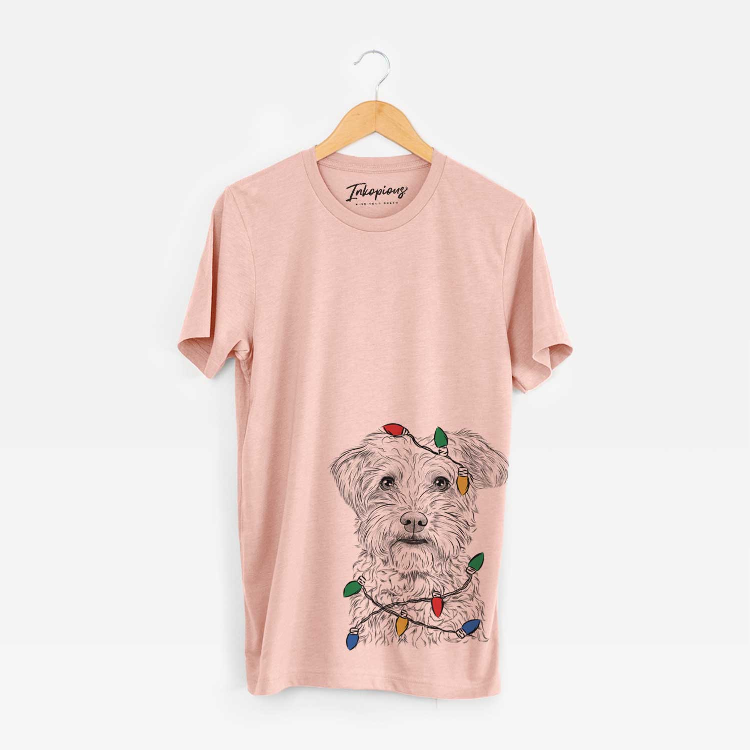 Hand-drawn sketch of Rudy the Schnoodle wrapped in Christmas lights on a Peach Unisex crewneck