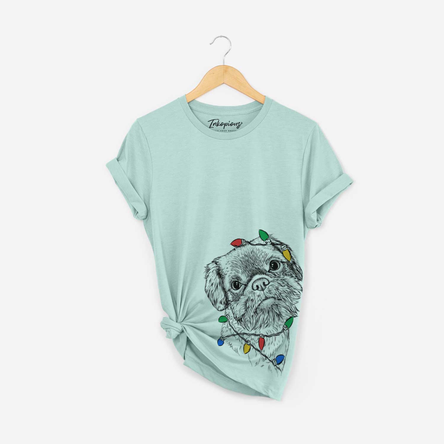 Hand-drawn sketch of Rufus the Shiffon wrapped in Christmas lights on a Heather Sage Unisex crewneck