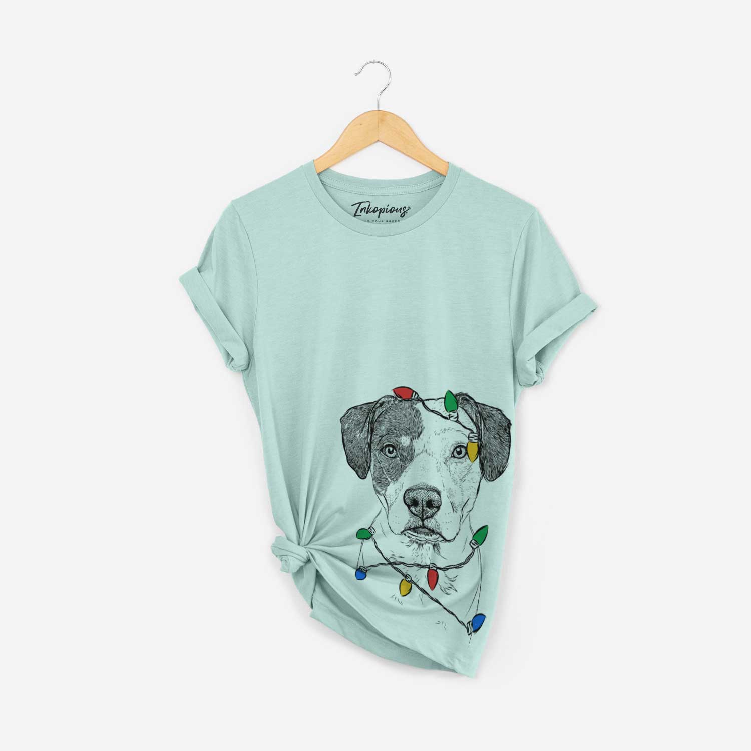Hand-drawn sketch of Ryleigh the Beagle Pitbull Mix wrapped in Christmas lights on a Heather Sage Unisex crewneck