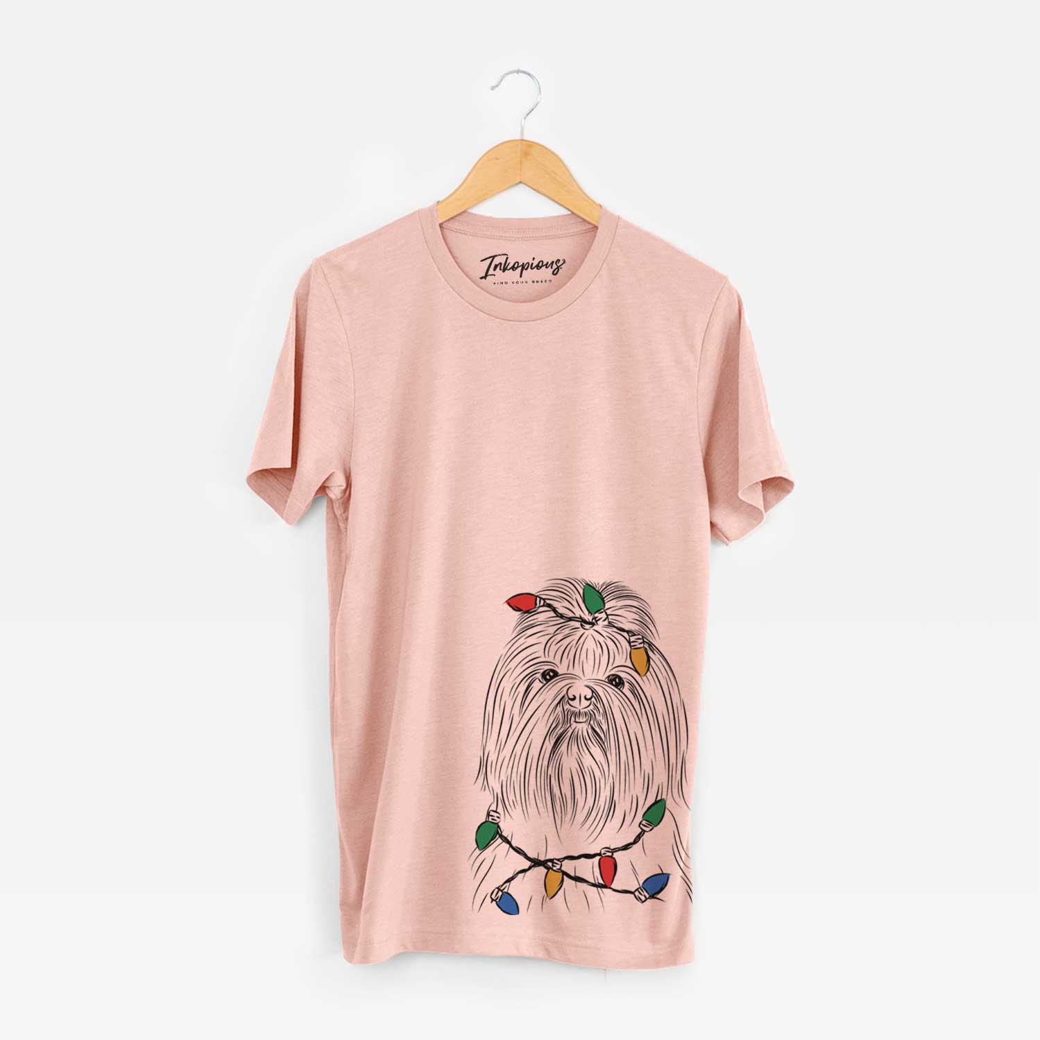 Hand-drawn sketch of Sabine the Shih Tzu wrapped in Christmas lights on a Peach Unisex crewneck