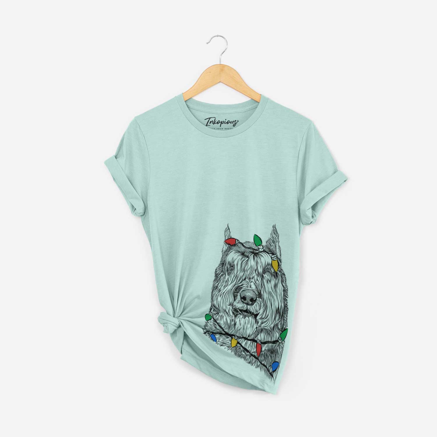 Hand-drawn sketch of Sabre the Bouvier Des Flandres wrapped in Christmas lights on a Heather Sage Unisex crewneck