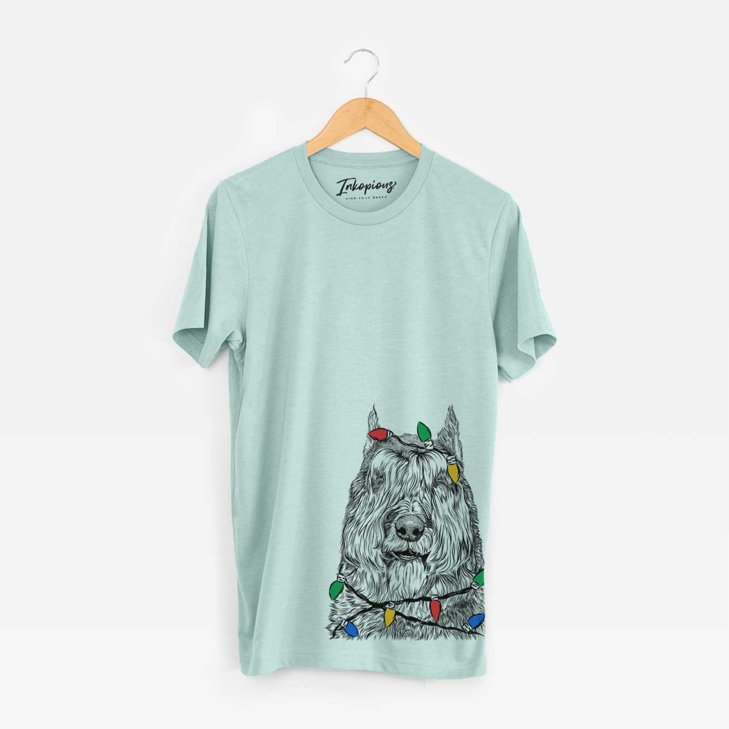 Hand-drawn sketch of Sabre the Bouvier Des Flandres wrapped in Christmas lights on a Heather Sage Unisex crewneck