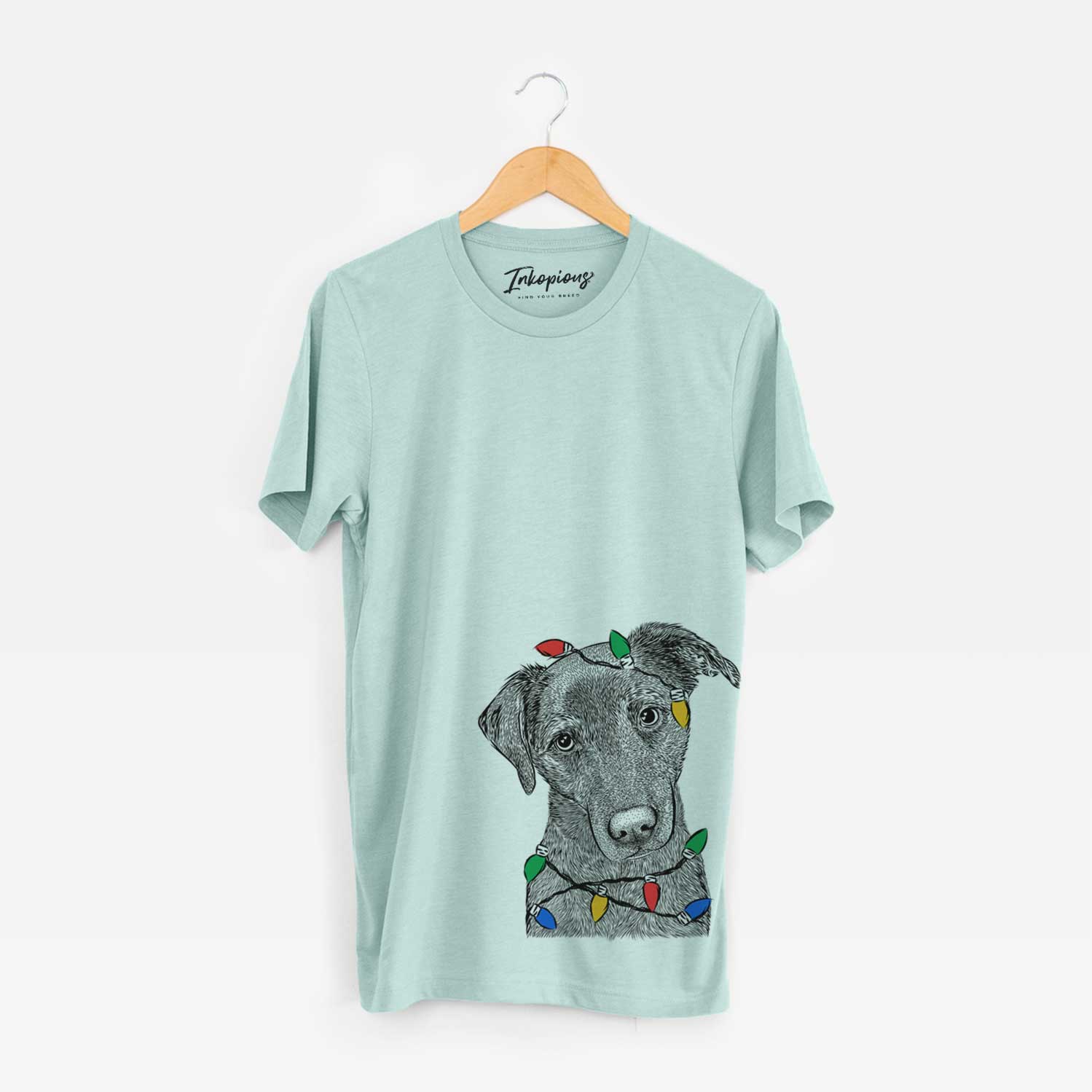 Hand-drawn sketch of Sadie the Whipador wrapped in Christmas lights on a Heather Sage Unisex crewneck