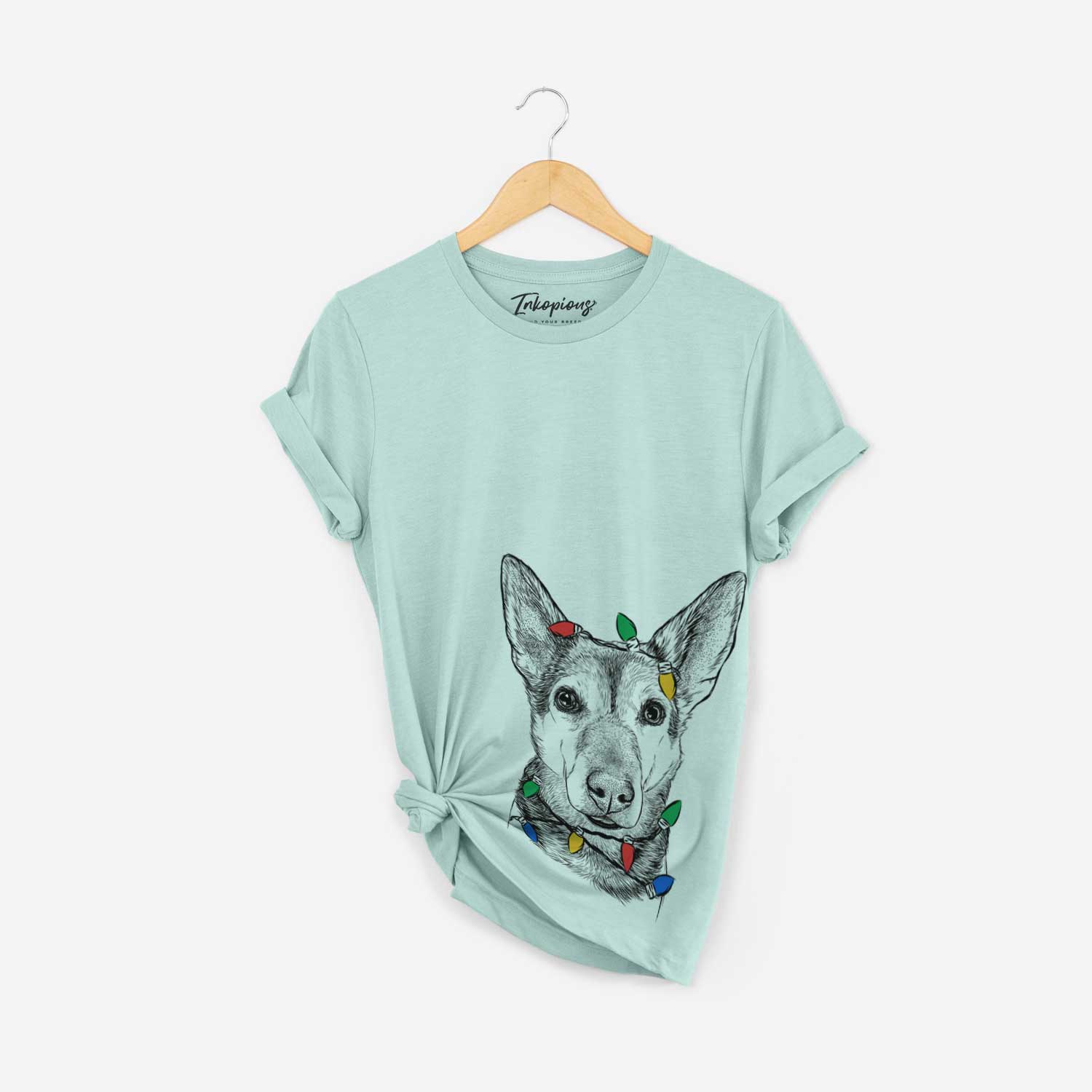 Hand-drawn sketch of Sammie the Mixed Breed wrapped in Christmas lights on a Heather Sage Unisex crewneck