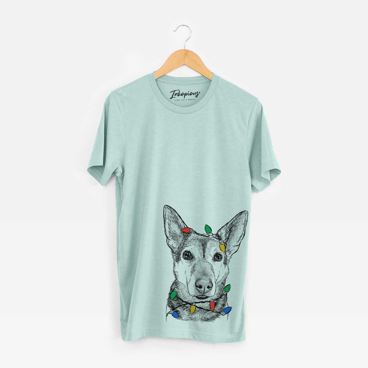 Hand-drawn sketch of Sammie the Mixed Breed wrapped in Christmas lights on a Heather Sage Unisex crewneck
