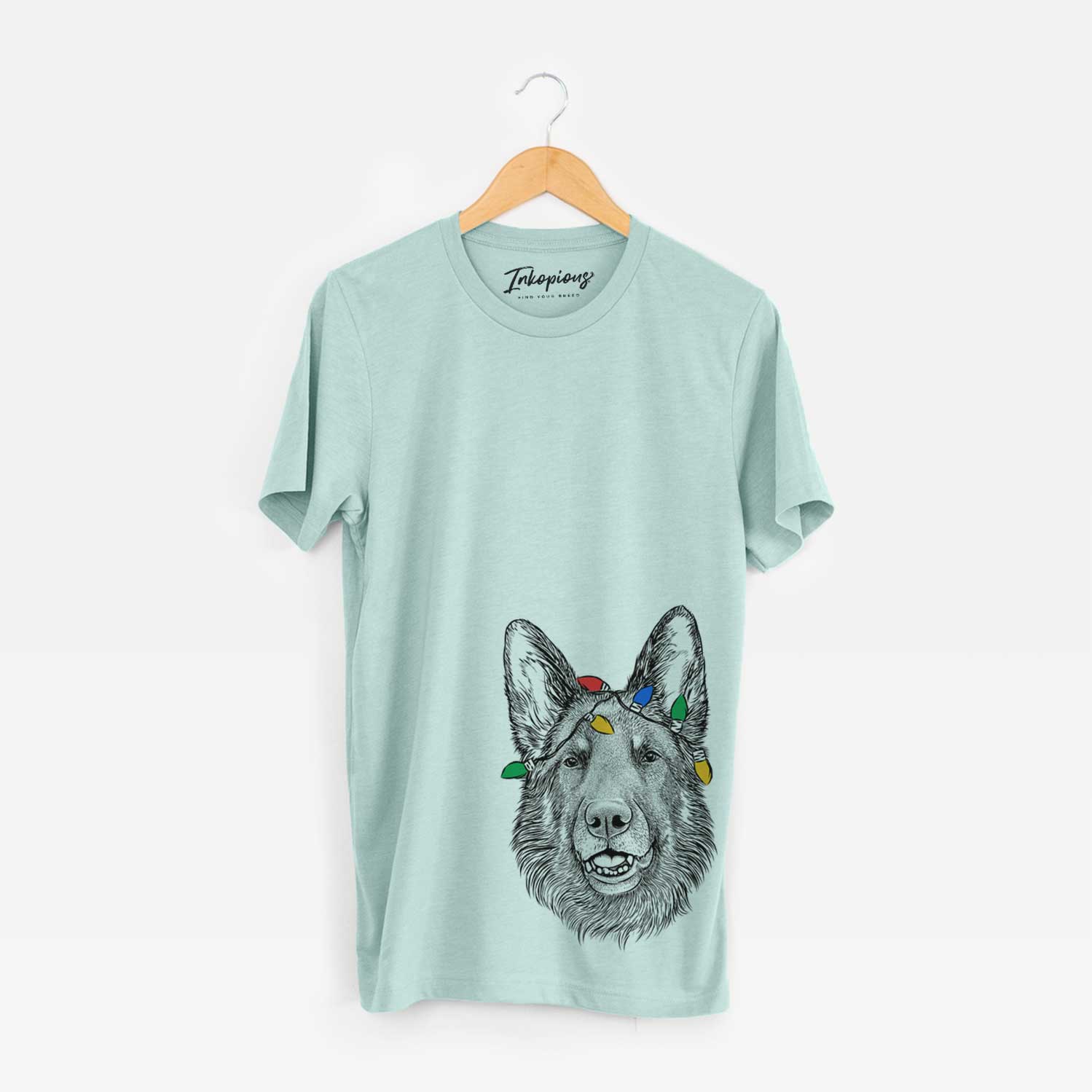 Hand-drawn sketch of Sammie the German Shepherd wrapped in Christmas lights on a Heather Sage Unisex crewneck