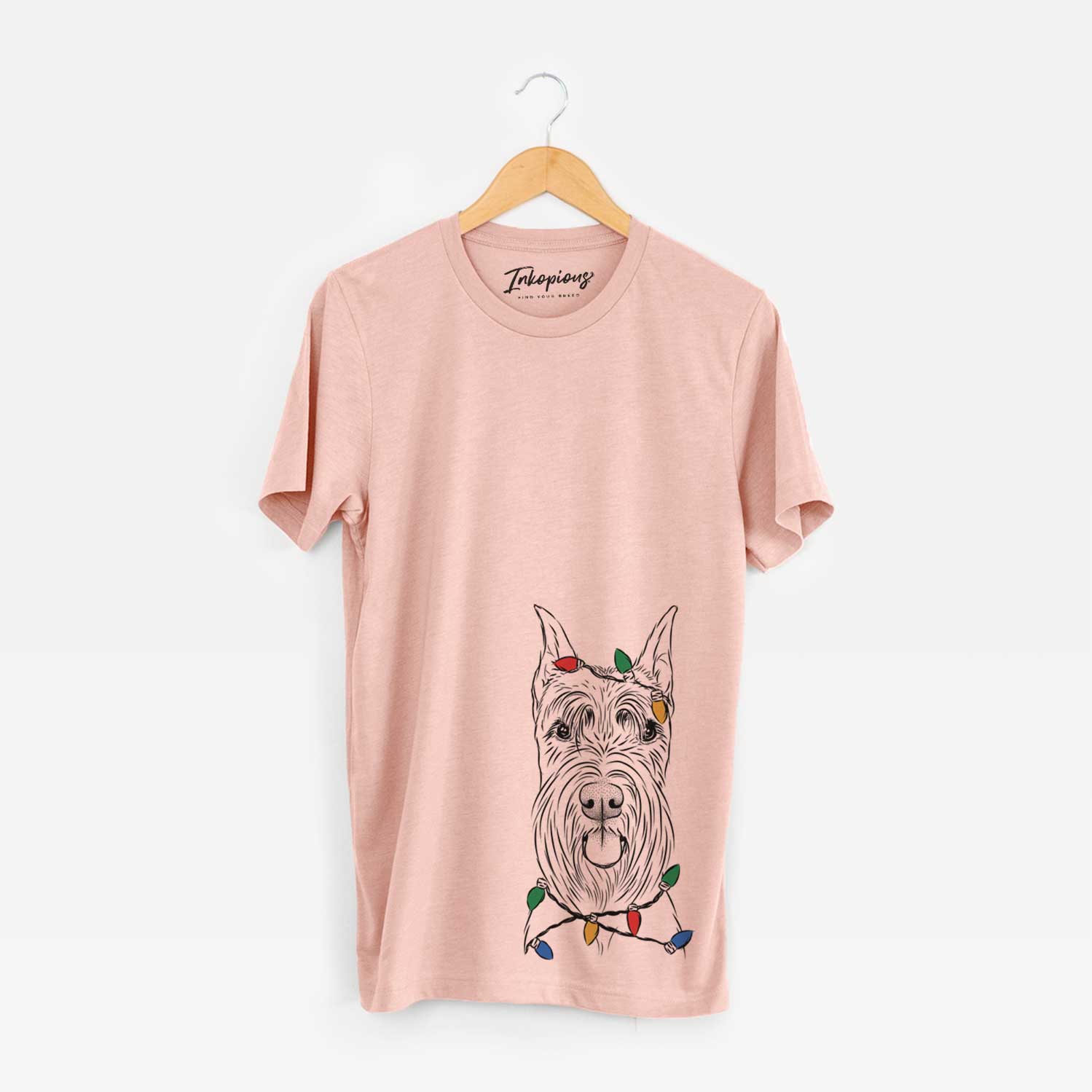 Hand-drawn sketch of Samuel the Standard Schnauzer wrapped in Christmas lights on a Peach Unisex crewneck