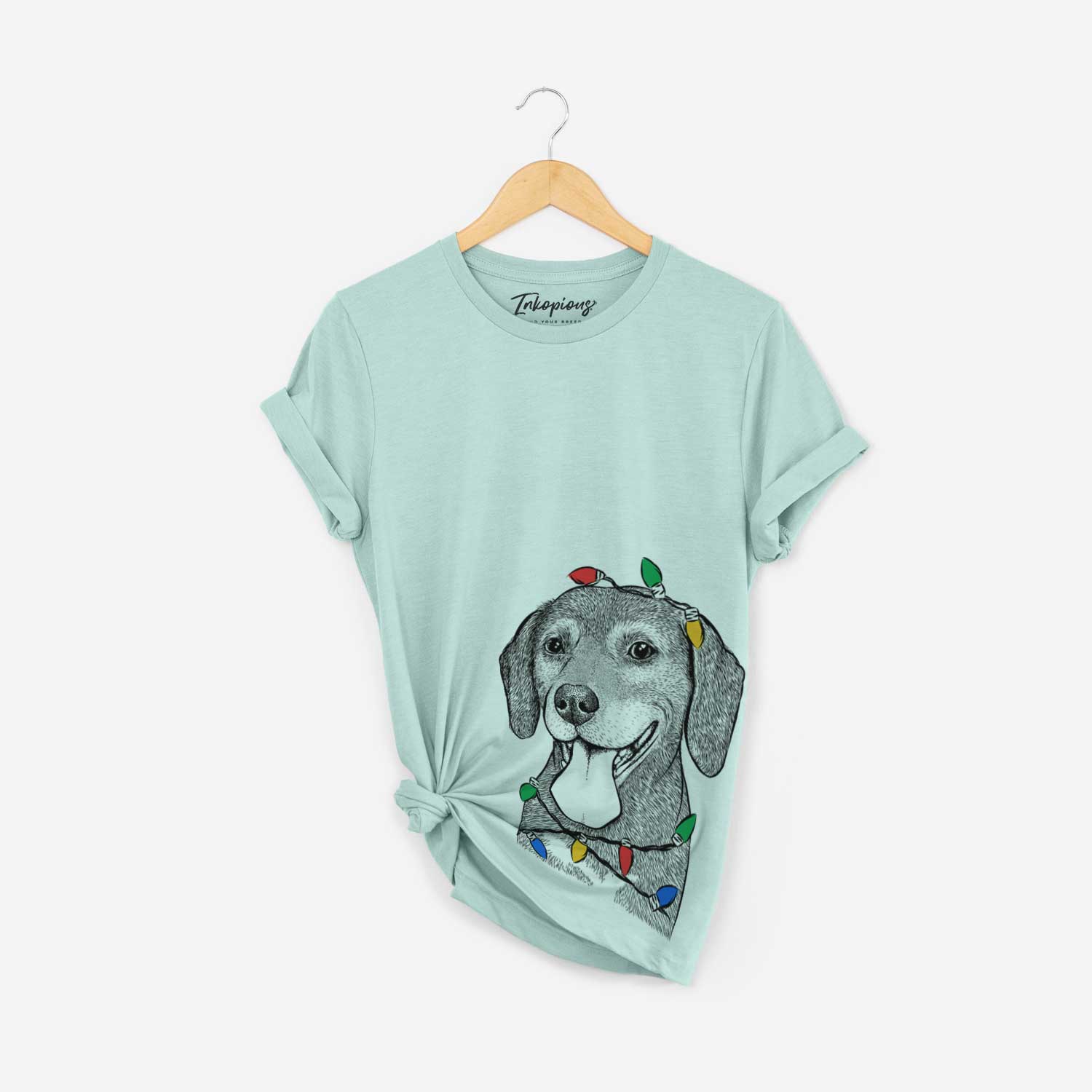Hand-drawn sketch of Scarlett the Beagle wrapped in Christmas lights on a Heather Sage Unisex crewneck