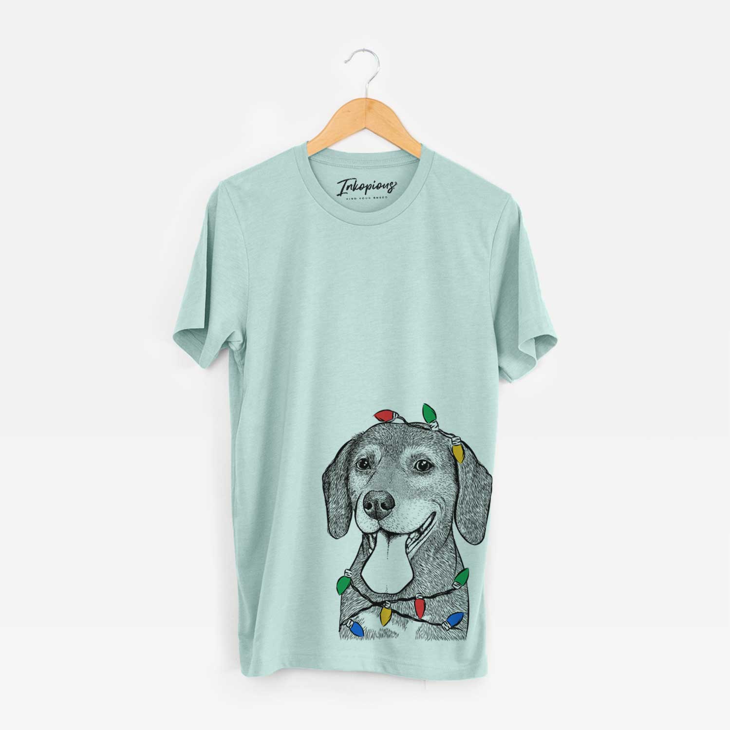 Hand-drawn sketch of Scarlett the Beagle wrapped in Christmas lights on a Heather Sage Unisex crewneck