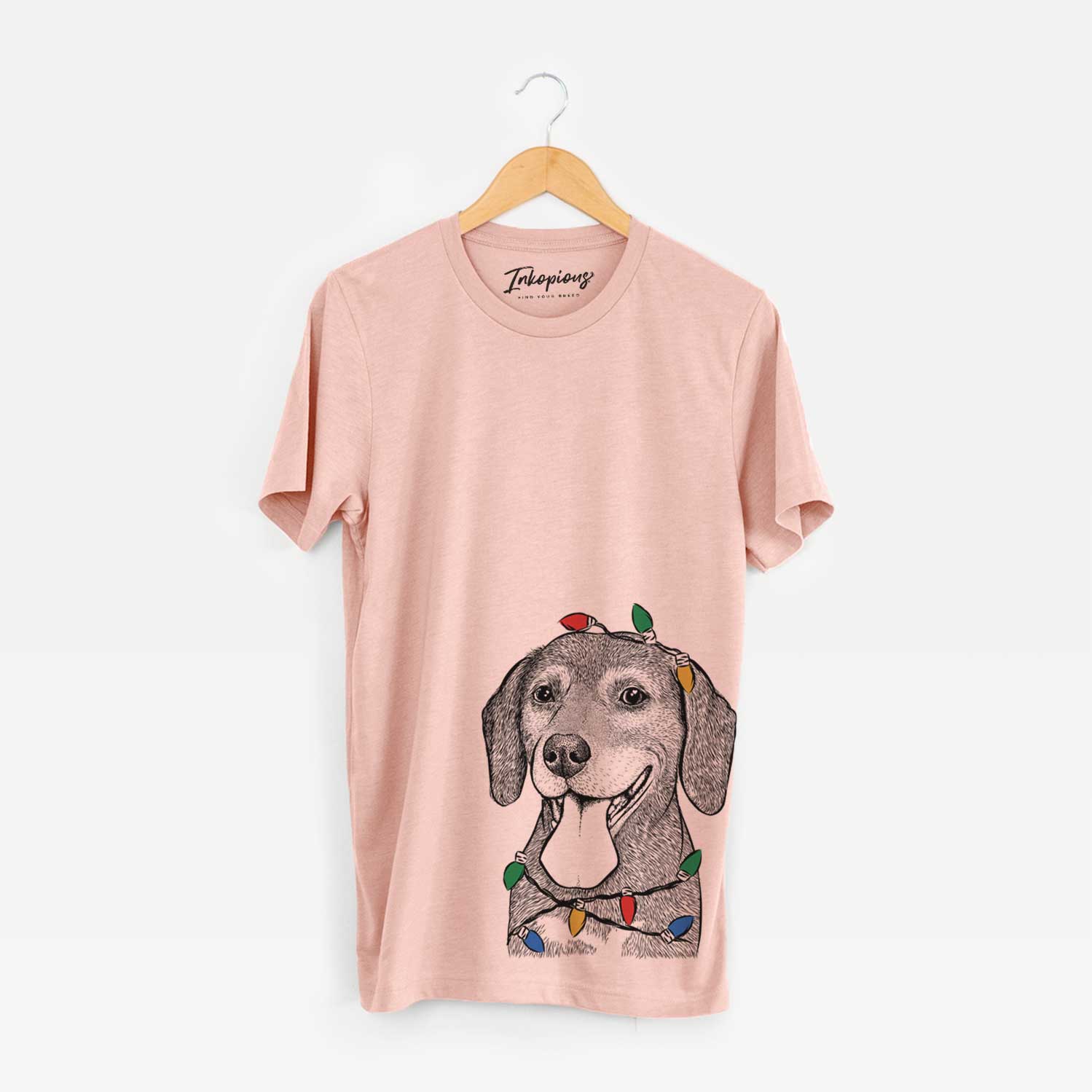 Hand-drawn sketch of Scarlett the Beagle wrapped in Christmas lights on a Peach Unisex crewneck