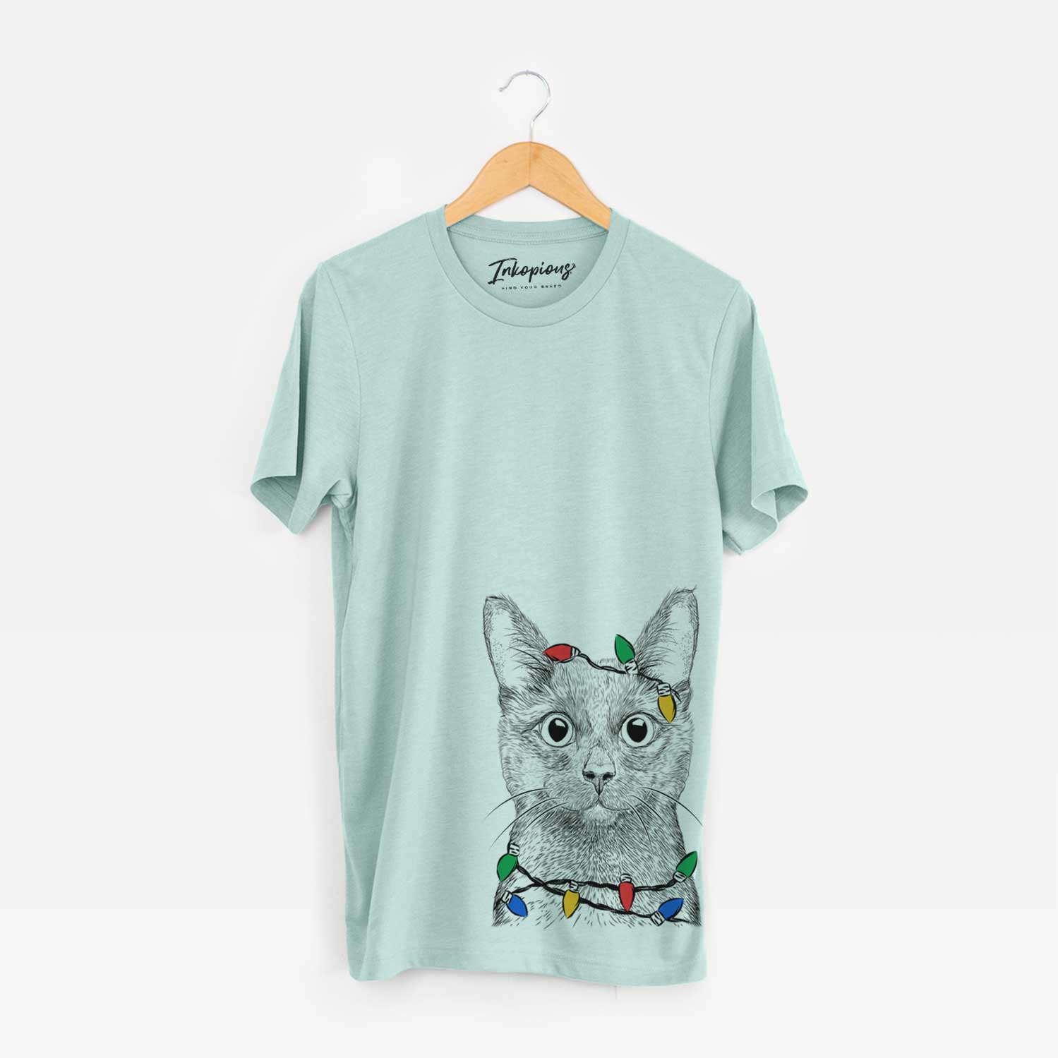 Hand-drawn sketch of Shadow the Black Cat wrapped in Christmas lights on a Heather Sage Unisex crewneck