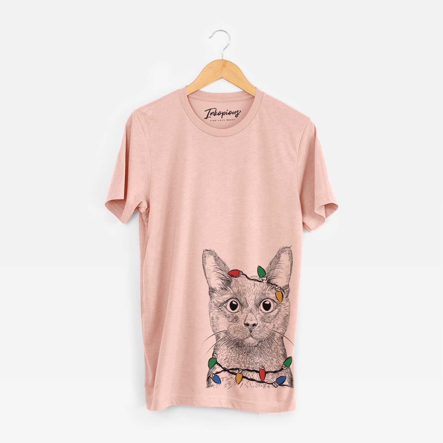 Hand-drawn sketch of Shadow the Black Cat wrapped in Christmas lights on a Peach Unisex crewneck