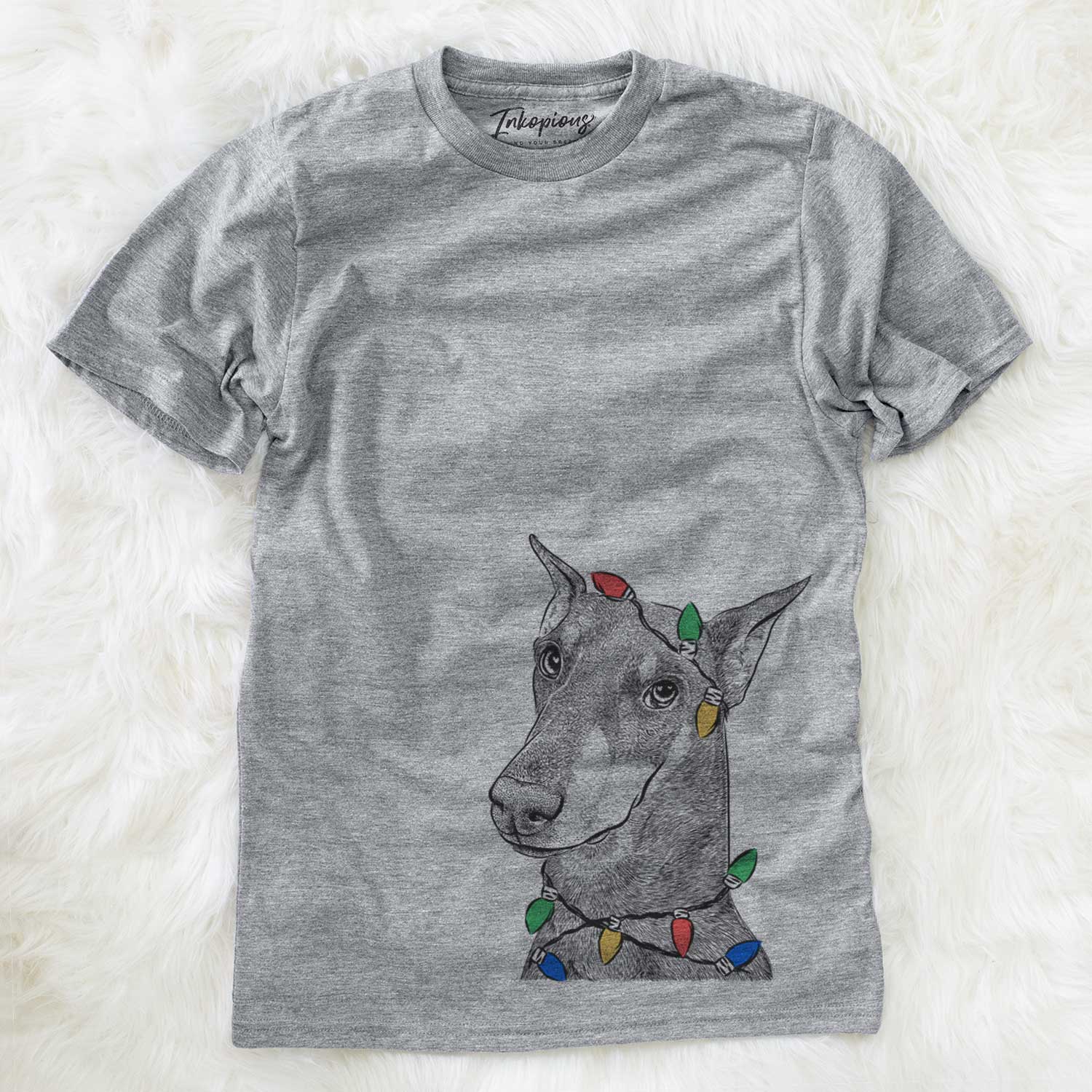 Hand-drawn sketch of Shelby the Doberman Pinscher wrapped in Christmas lights on a Grey Unisex crewneck