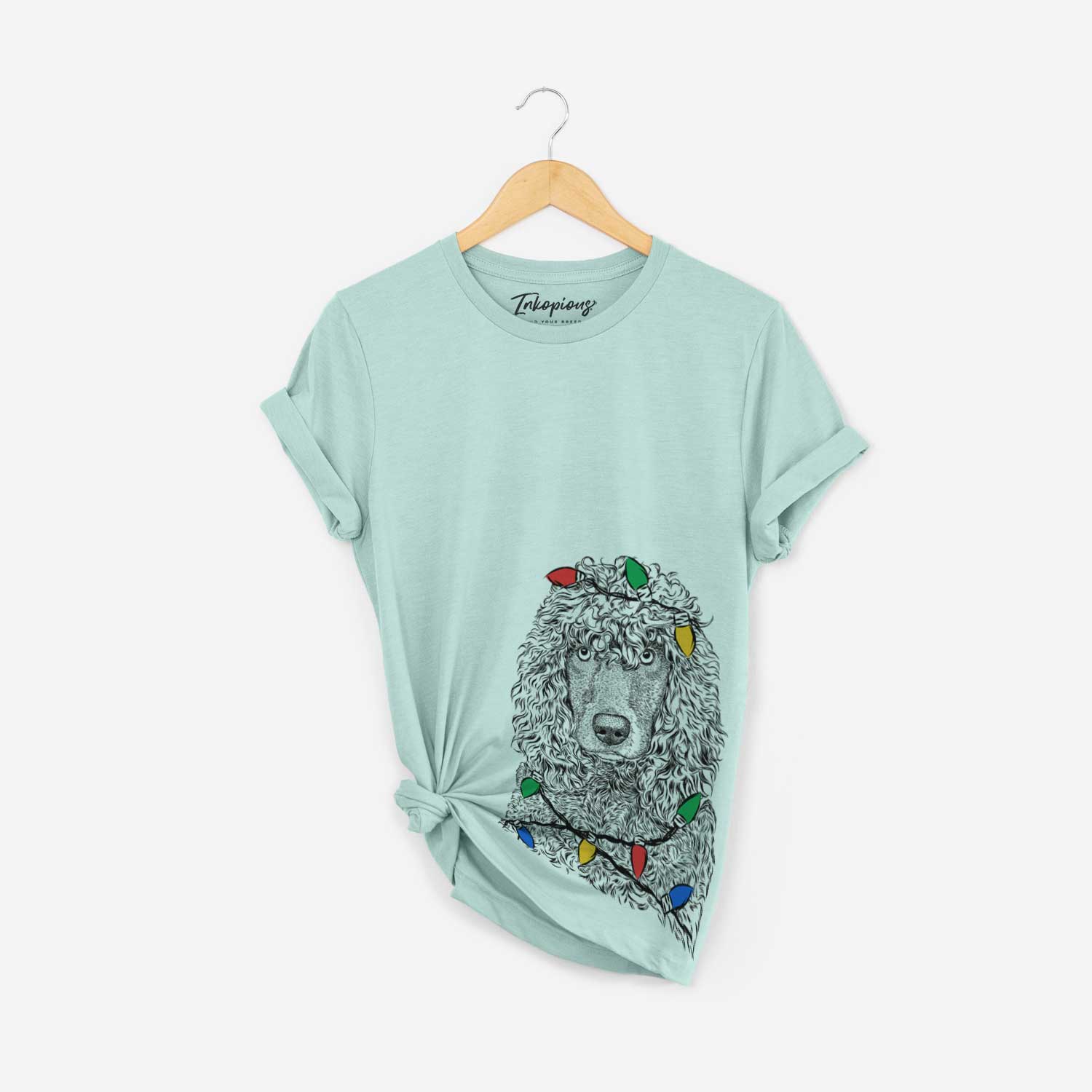 Hand-drawn sketch of Shilo the Irish Water Spaniel wrapped in Christmas lights on a Heather Sage Unisex crewneck