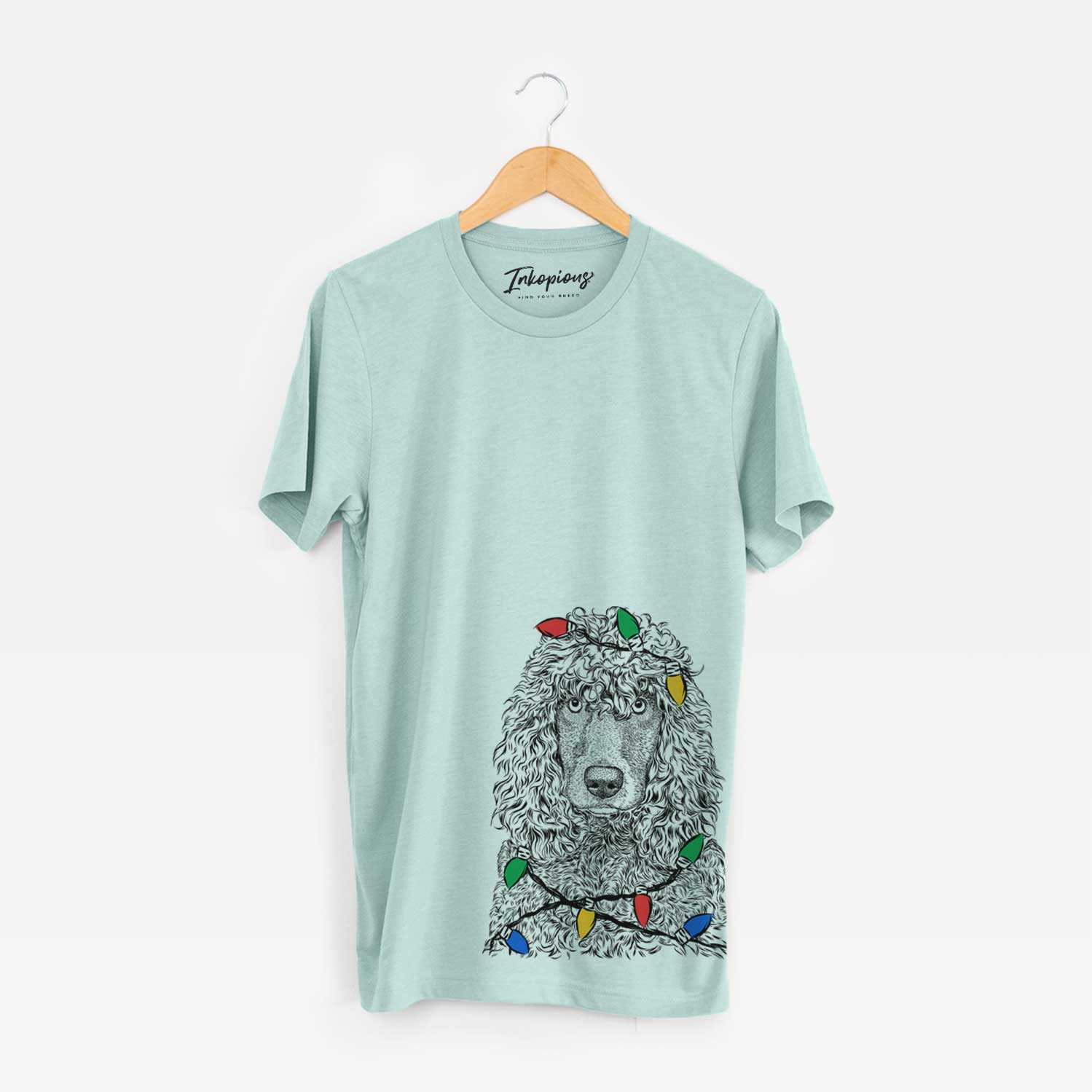 Hand-drawn sketch of Shilo the Irish Water Spaniel wrapped in Christmas lights on a Heather Sage Unisex crewneck
