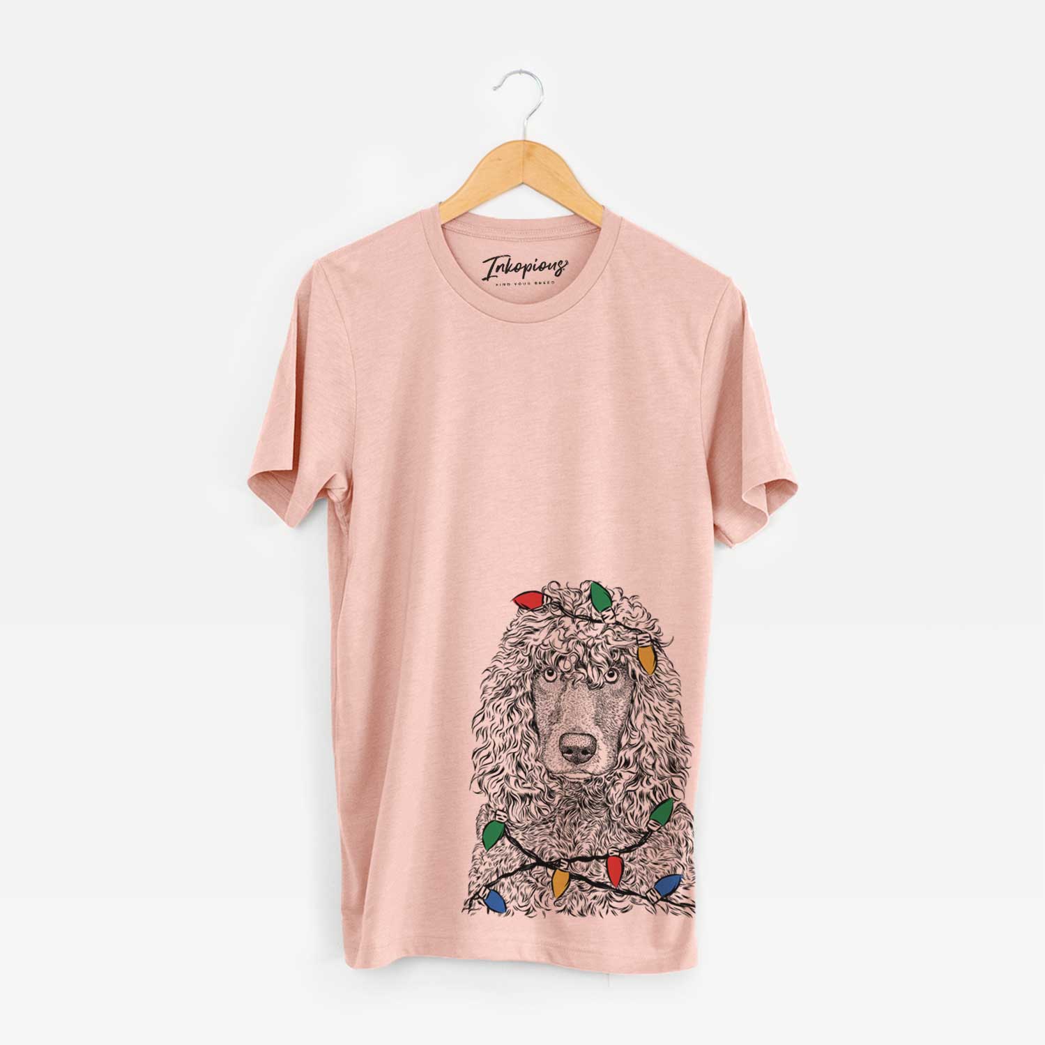 Hand-drawn sketch of Shilo the Irish Water Spaniel wrapped in Christmas lights on a Peach Unisex crewneck
