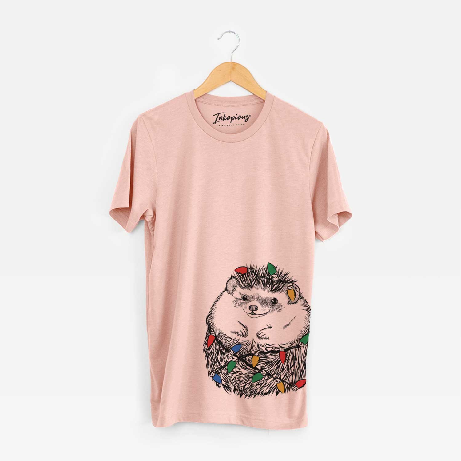 Hand-drawn sketch of Sid the Hedgehog wrapped in Christmas lights on a Peach Unisex crewneck