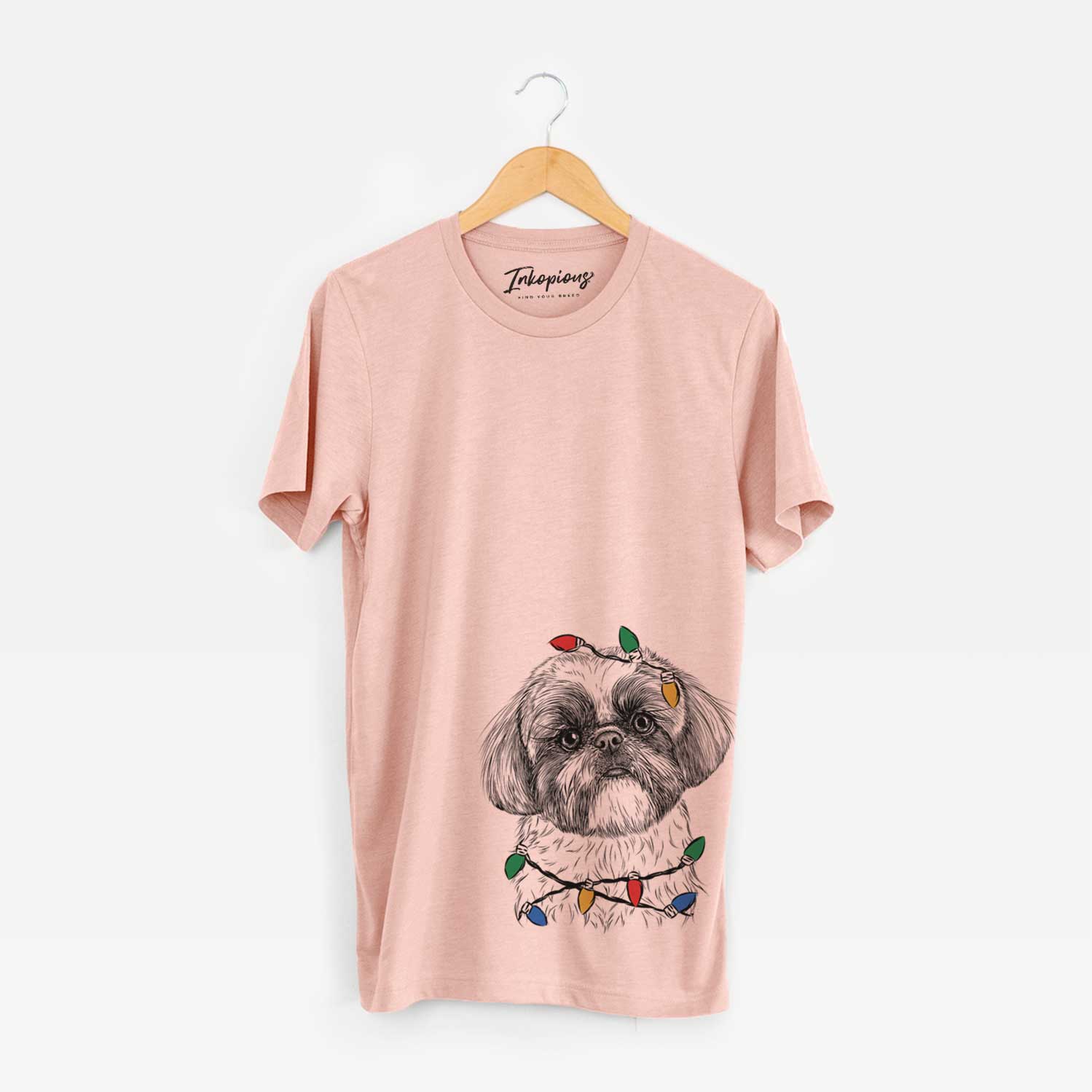 Hand-drawn sketch of Simon the Shih Tzu wrapped in Christmas lights on a Peach Unisex crewneck