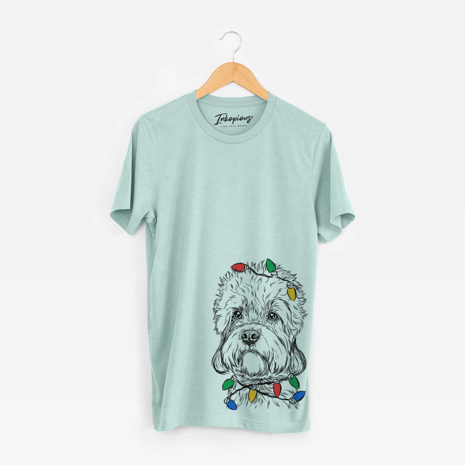 Hand-drawn sketch of Sir Walter the Dandie Dinmont Terrier wrapped in Christmas lights on a Heather Sage Unisex crewneck