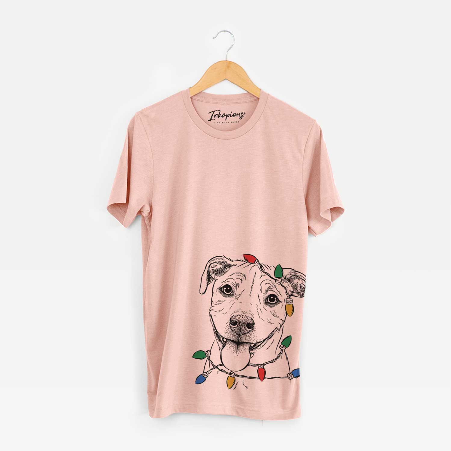 Hand-drawn sketch of Skye the Pitweiler wrapped in Christmas lights on a Peach Unisex crewneck