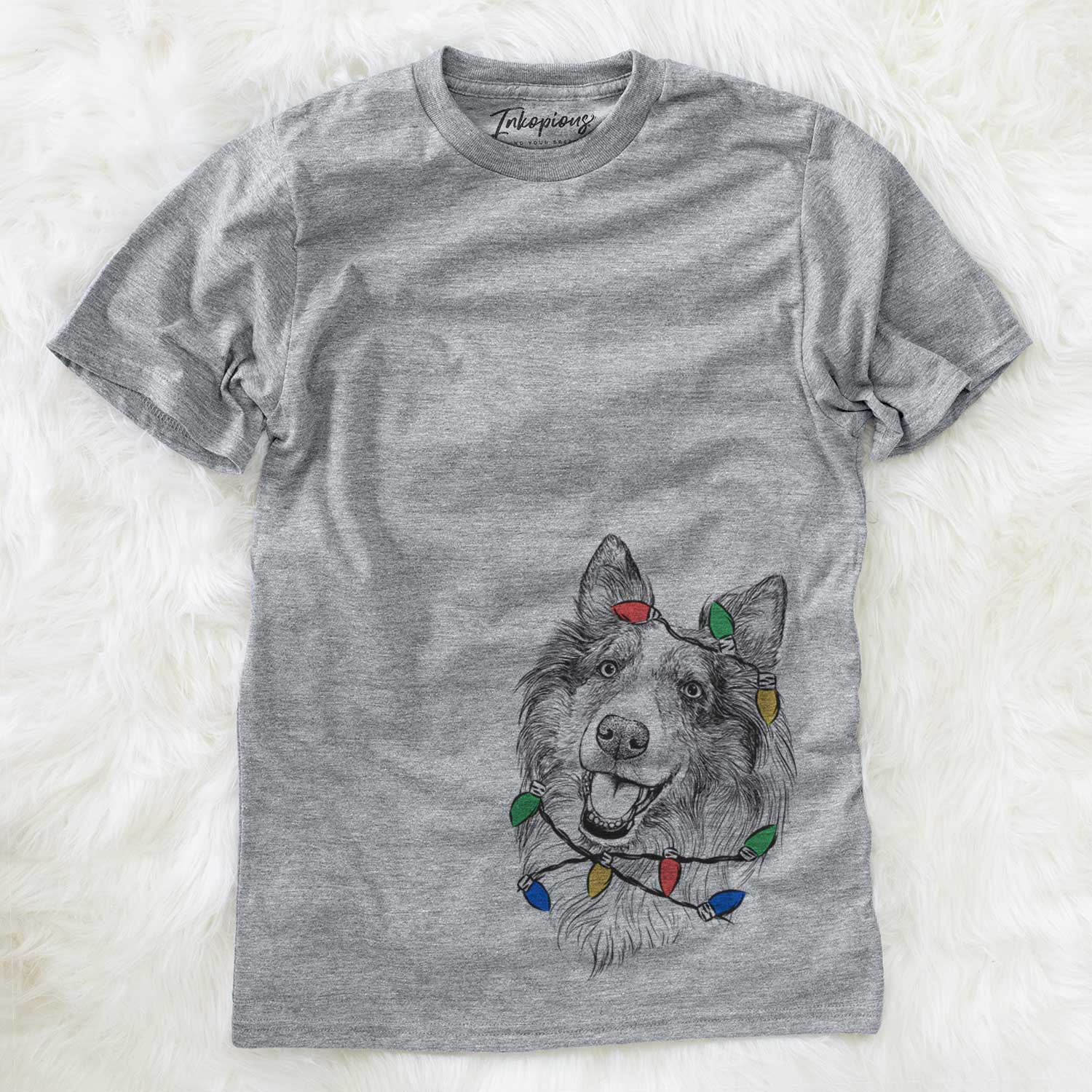Hand-drawn sketch of Skylar the Shetland Sheepdog wrapped in Christmas lights on a Grey Unisex crewneck