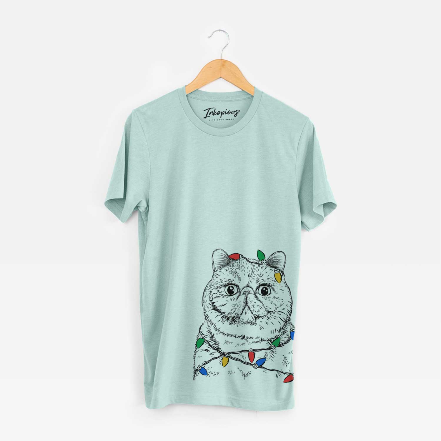Hand-drawn sketch of Squish the Exotic Shorthair Cat wrapped in Christmas lights on a Heather Sage Unisex crewneck