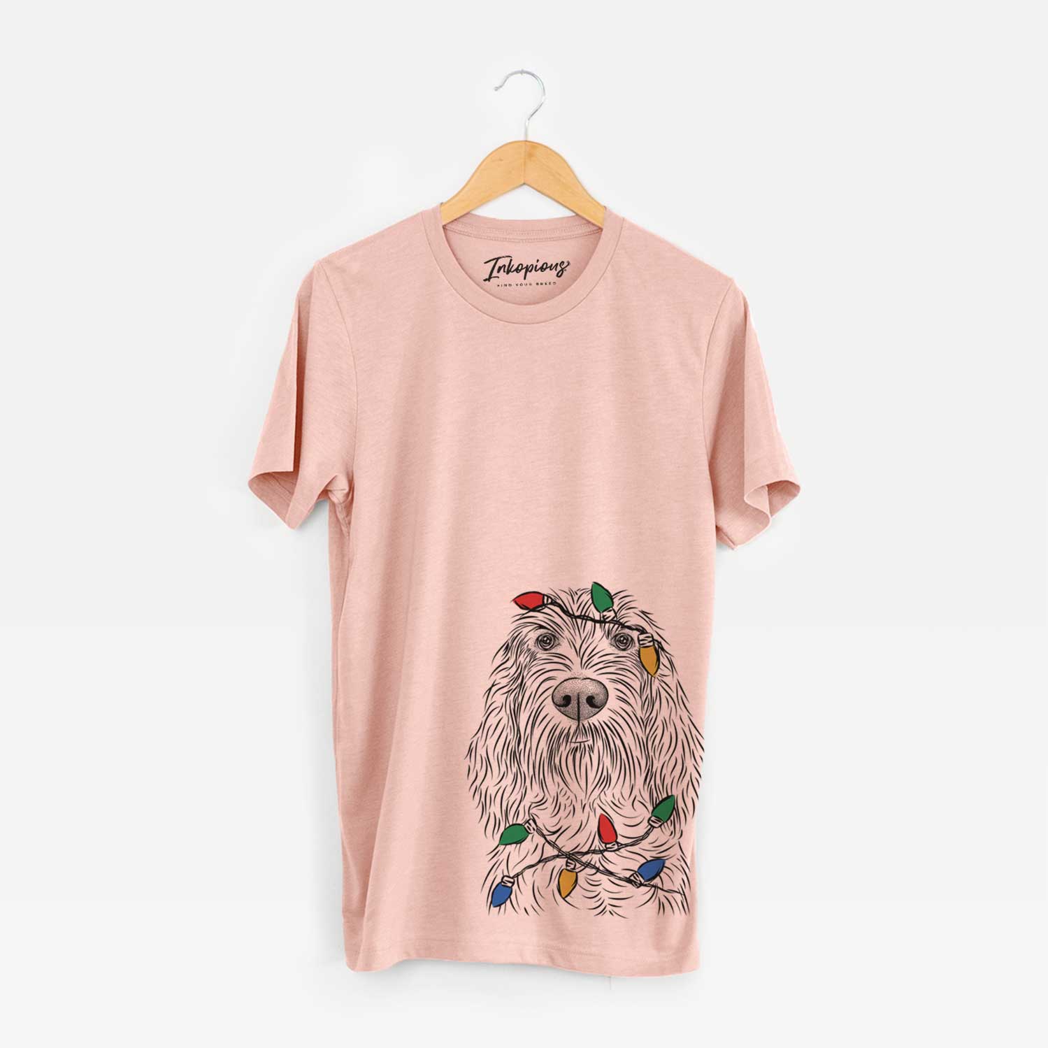 Hand-drawn sketch of Stefano the Spinone Italiano wrapped in Christmas lights on a Peach Unisex crewneck