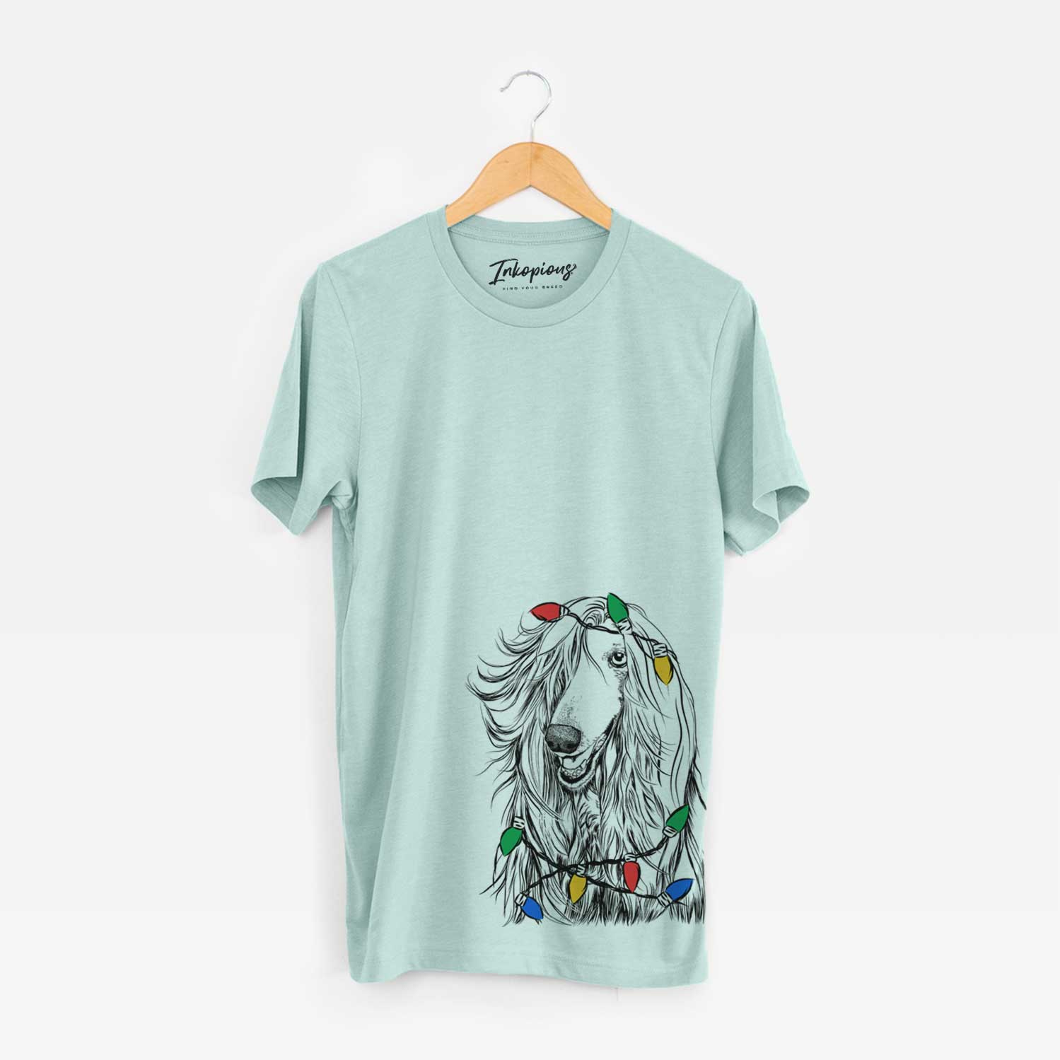 Hand-drawn sketch of Sterling the Afghan Hound wrapped in Christmas lights on a Heather Sage Unisex crewneck