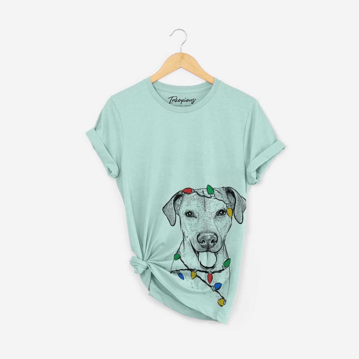 Hand-drawn sketch of Sugar the American Staffordshire Mix wrapped in Christmas lights on a Heather Sage Unisex crewneck