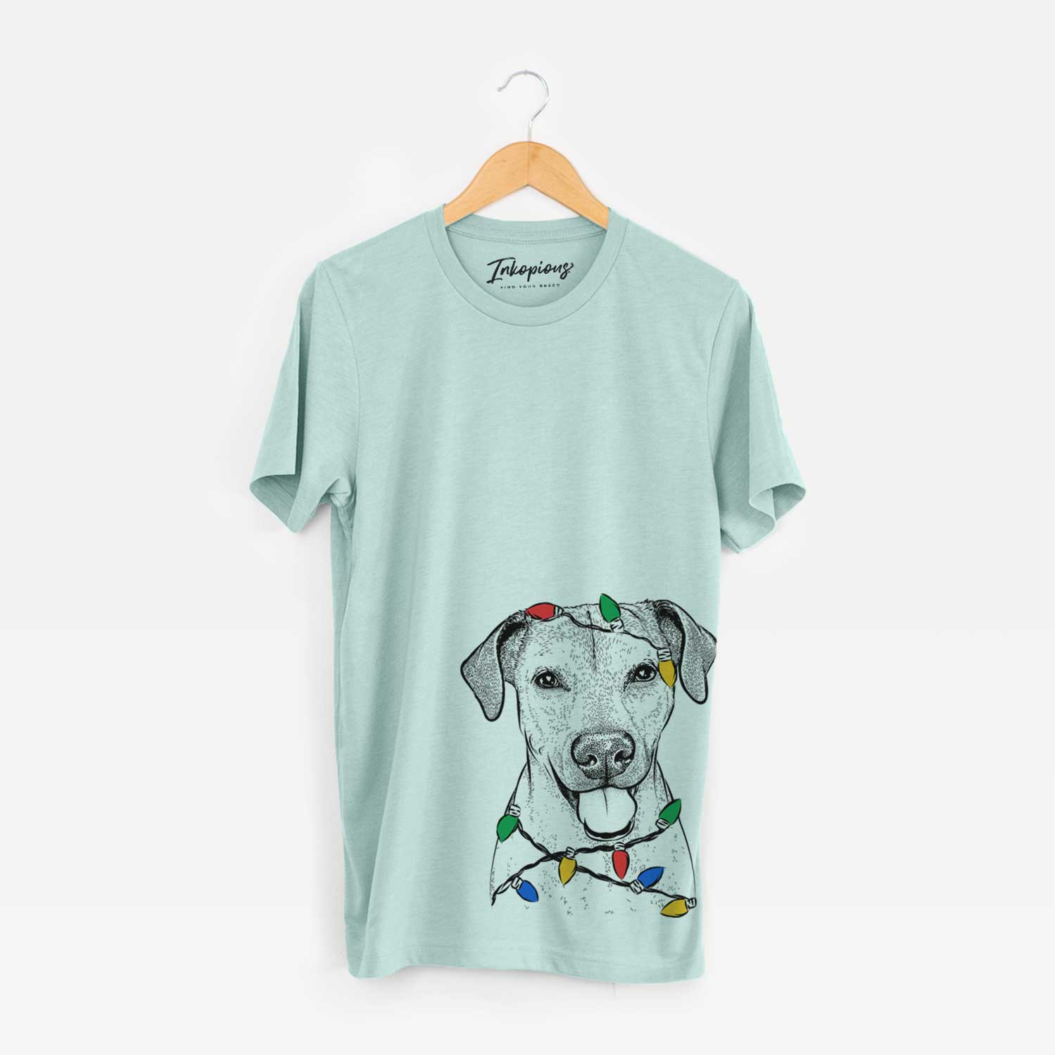 Hand-drawn sketch of Sugar the American Staffordshire Mix wrapped in Christmas lights on a Heather Sage Unisex crewneck