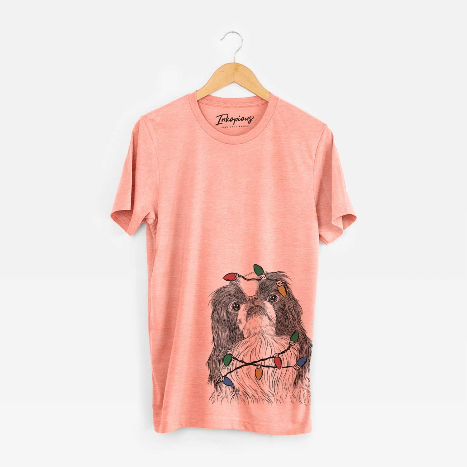 Hand-drawn sketch of Suki the Japanese Chin wrapped in Christmas lights on a Sunset Unisex crewneck