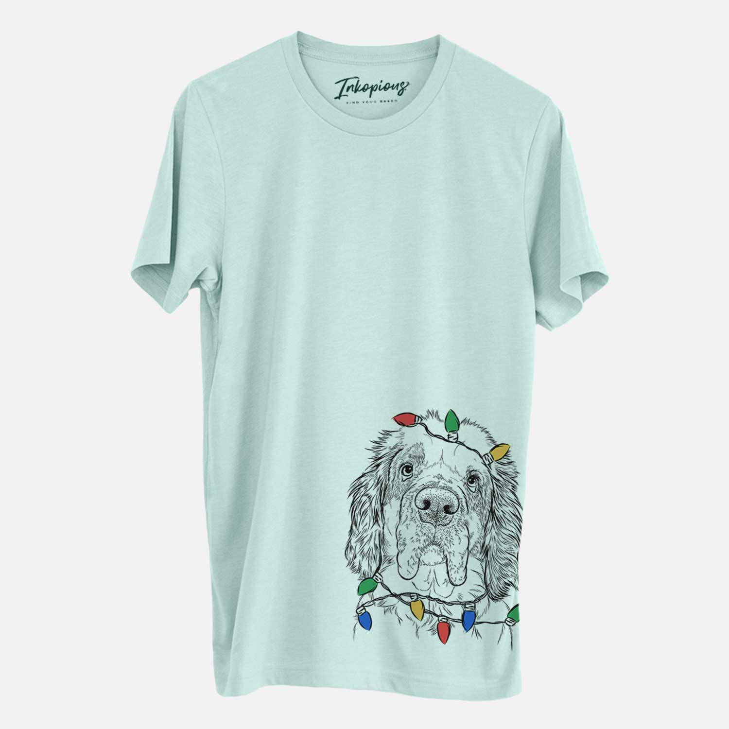 Hand-drawn sketch of Sully the Clumber Spaniel wrapped in Christmas lights on a Heather Sage Unisex crewneck