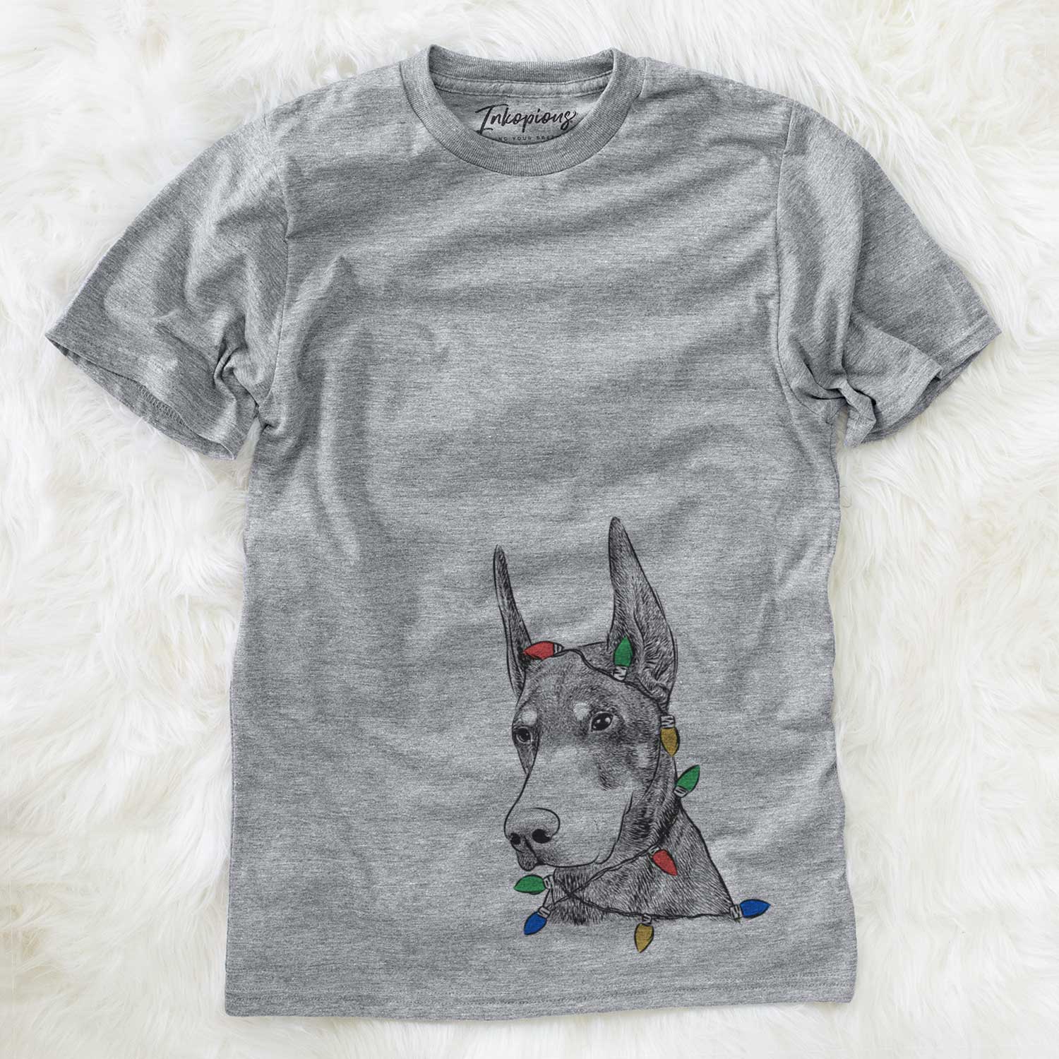 Hand-drawn sketch of Sunny the Doberman Pinscher wrapped in Christmas lights on a Grey Unisex crewneck