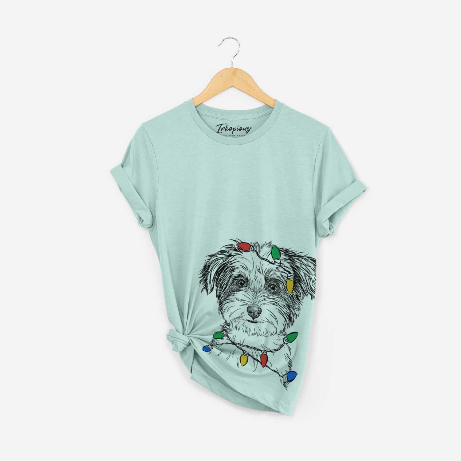 Hand-drawn sketch of Teddy the Havanese wrapped in Christmas lights on a Heather Sage Unisex crewneck