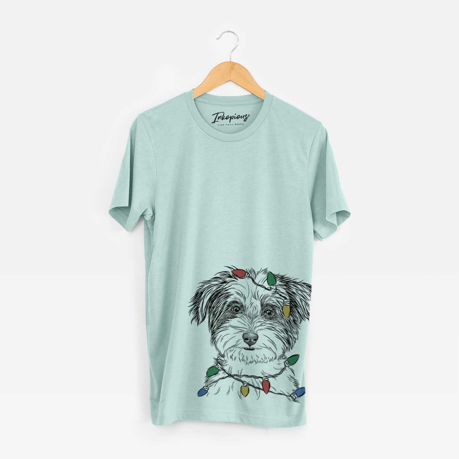 Hand-drawn sketch of Teddy the Havanese wrapped in Christmas lights on a Heather Sage Unisex crewneck