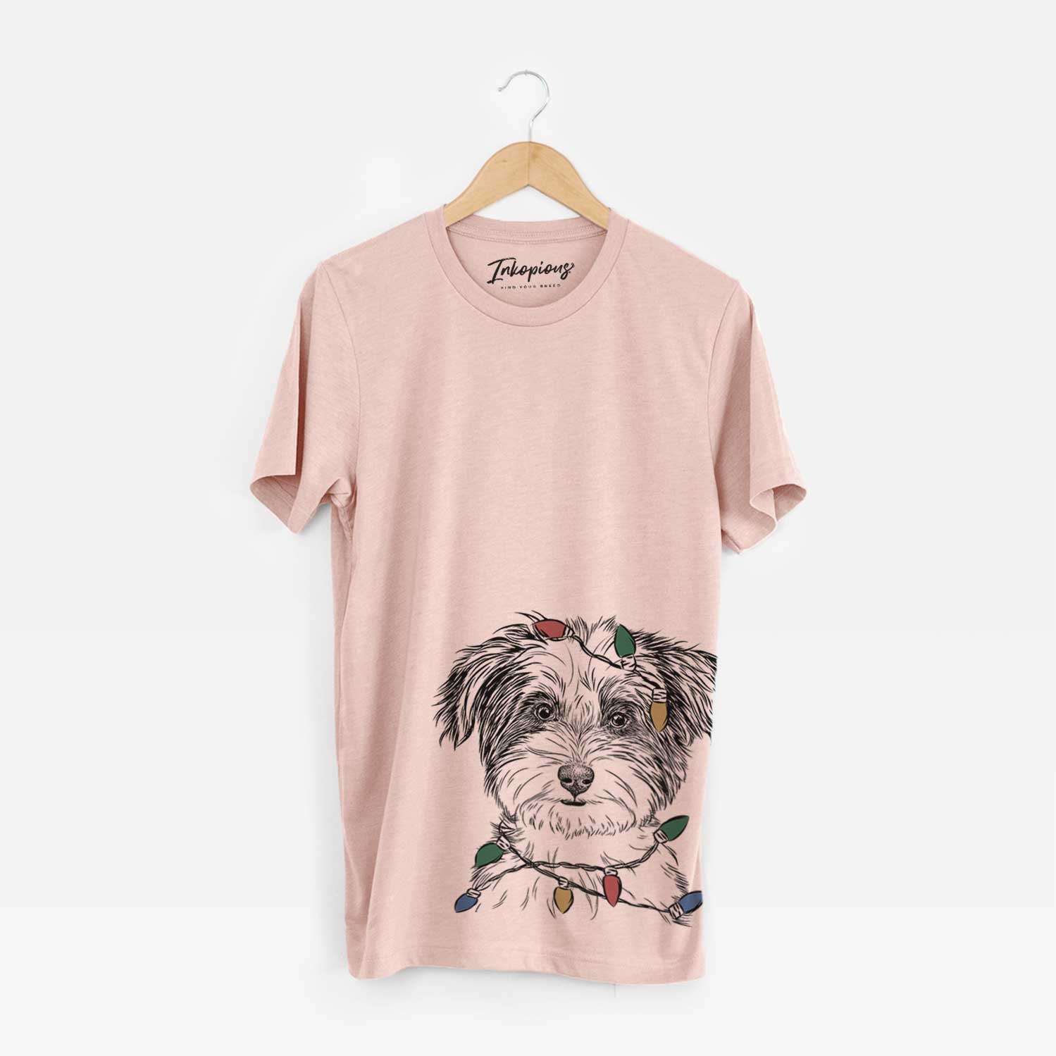 Hand-drawn sketch of Teddy the Havanese wrapped in Christmas lights on a Peach Unisex crewneck